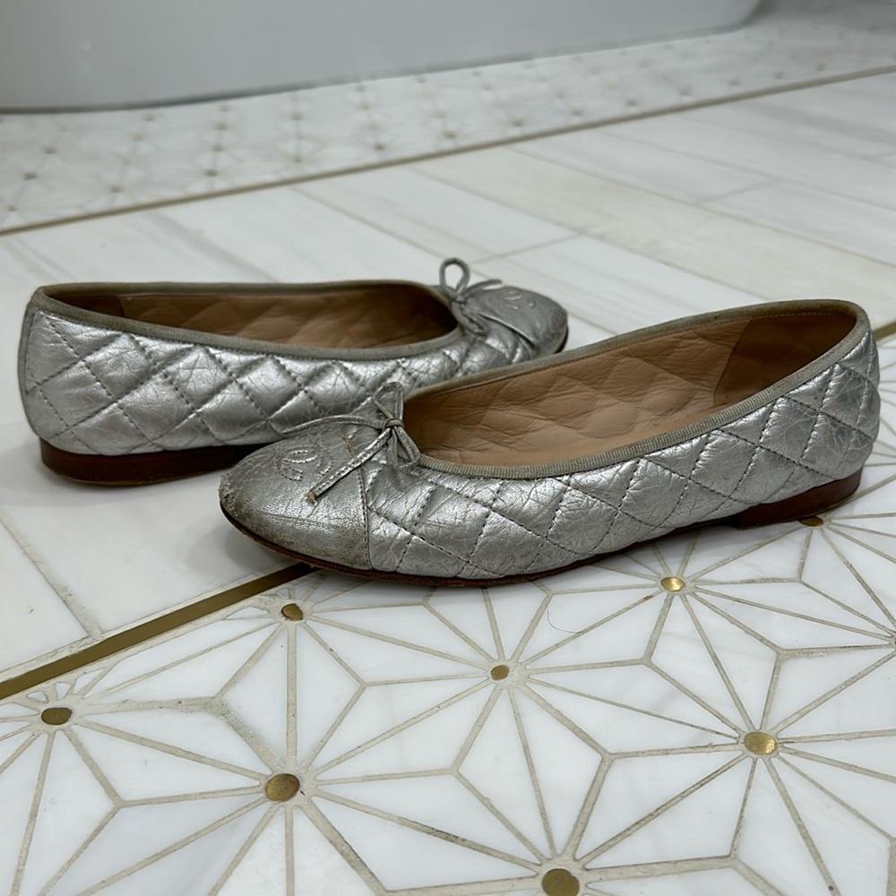 Chanel quilted, distressed, metallic silver ballerina flats.
